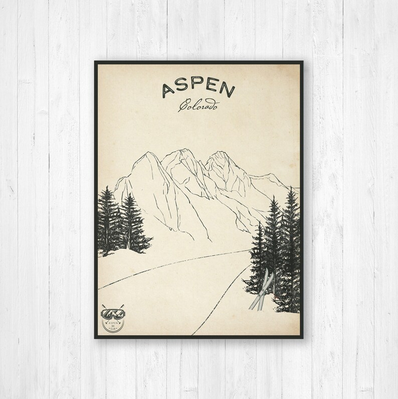 May include: A black and white illustration of a mountain range with a ski slope in the foreground. The text "ASPEN Colorado" is at the top of the image. There are two pairs of skis and ski poles in the foreground.