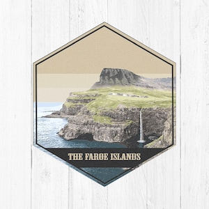May include: A hexagonal travel sticker featuring a scenic image of a waterfall cascading down a cliffside in the Faroe Islands. The text "THE FAROE ISLANDS" is printed in black at the bottom of the sticker.