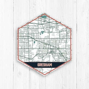 May include: A hexagonal map of Gresham, Oregon, with a white background and black lines representing streets. The map is surrounded by a red border and a dark blue banner with the word "GRESHAM" in white text.