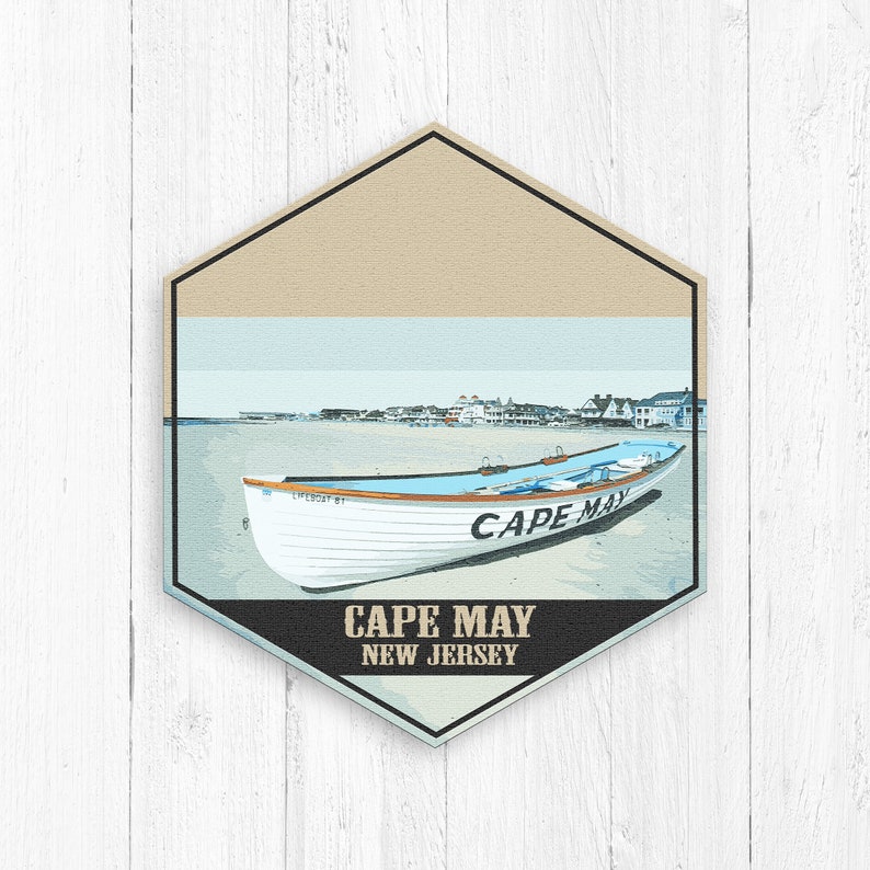 May include: A vintage-style illustration of a white lifeboat with the text "CAPE MAY" on the side, set against a beach scene with a cityscape in the background. The text "CAPE MAY NEW JERSEY" is displayed below the boat.