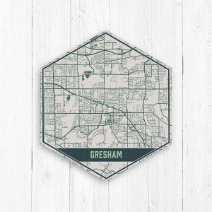 May include: A hexagonal map of Gresham, Oregon, with a white background and green lines representing streets. The city name is printed in a dark blue banner at the bottom.