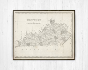 May include: Framed vintage map of Kentucky in shades of gray and beige. The map features detailed geographical information, including state boundaries, cities, and rivers. The word "Kentucky" is printed at the top. The map is enclosed in a dark brown frame.