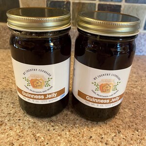 May include: Two glass jars of Guinness Jelly with gold lids and white labels. The labels read "My Country Cupboard" and "Guinness Jelly". Each jar contains 9 oz. (255 grams) of jelly.