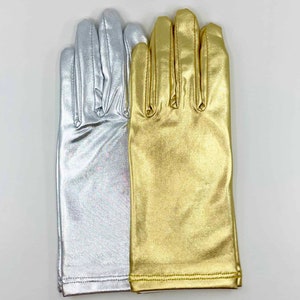 May include: A pair of fingerless gloves, one silver and one gold. The gloves are made of a shiny, metallic fabric.