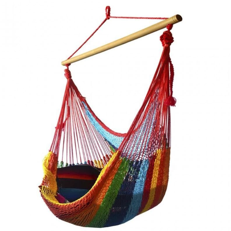May include: A colorful hanging chair made of woven threads. The chair features a rainbow of colors, including red, orange, yellow, green, blue, and purple. It is suspended from a wooden bar and red rope.