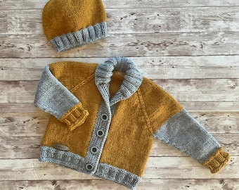 May include: Mustard yellow and gray knitted baby cardigan and matching beanie hat. The cardigan has a button-up front and gray sleeves. The beanie has a gray brim. The set is made of soft yarn and is perfect for keeping a baby warm.