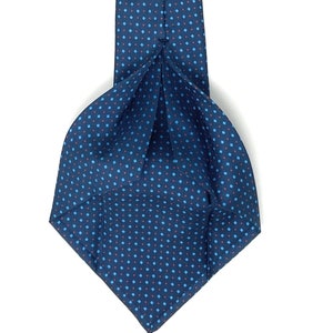 May include: A dark blue patterned tie with a white label that reads "WILMOK ROME". The tie has a small, repeating pattern of red and blue squares.