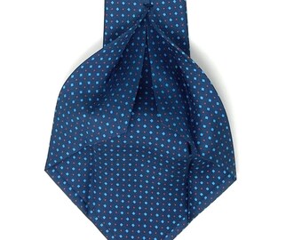 May include: A dark blue patterned tie with a white label that reads "WILMOK ROME". The tie has a small, repeating pattern of red and blue squares.