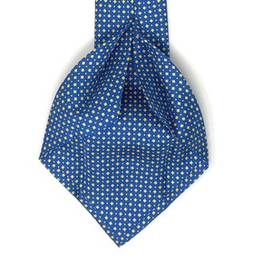 May include: A blue silk tie with a yellow diamond pattern. The tie has a label that reads "WILMOK ROME".