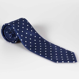 May include: A navy blue tie with white polka dots.