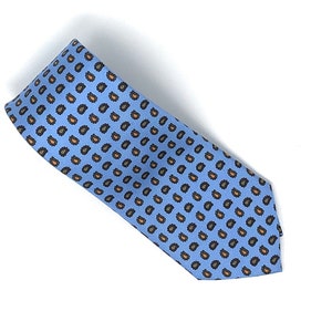 May include: A light blue tie with a paisley pattern in shades of brown and orange.
