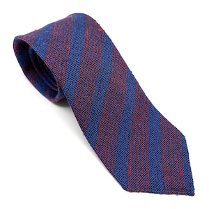 May include: A blue necktie with red vertical stripes. The tie is made of a textured fabric and is angled across a white background. The tie is a classic accessory for formal or business attire.