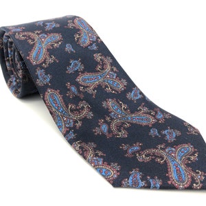 May include: A dark blue paisley patterned tie with red, blue, and gold accents.