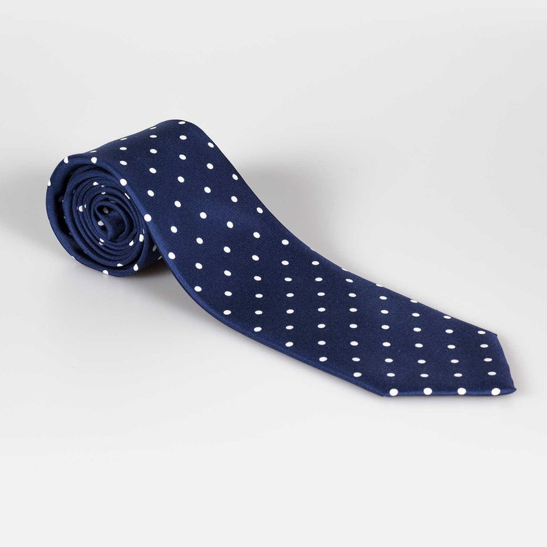 May include: A navy blue tie with white polka dots.