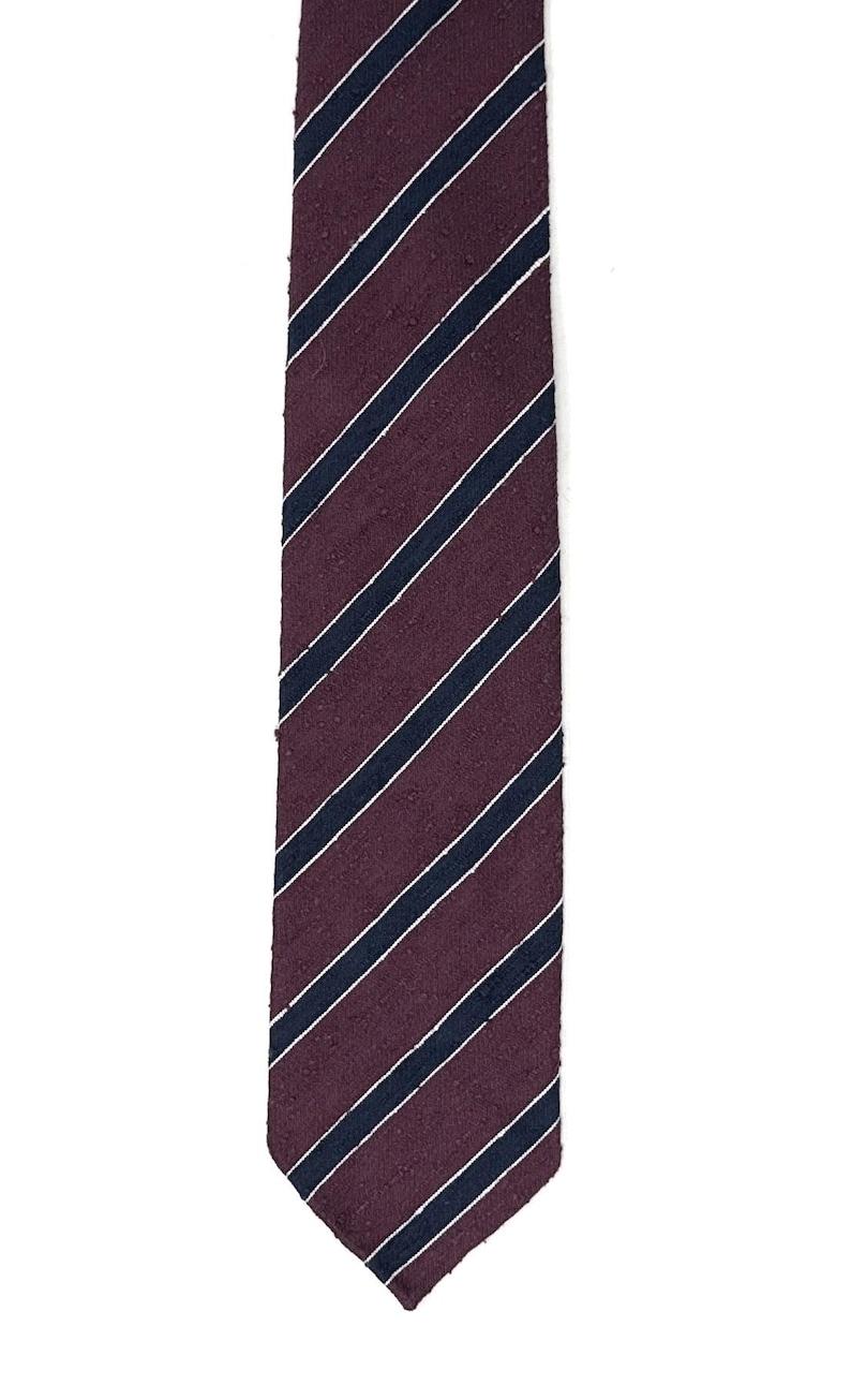 May include: A burgundy and navy blue striped tie. The tie has a diagonal stripe pattern.