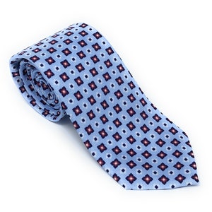 May include: A light blue tie with a repeating pattern of small red, white, and blue squares.