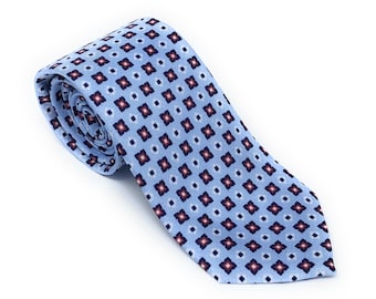 May include: A light blue tie with a repeating pattern of small red, white, and blue squares.