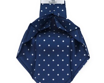 May include: A navy blue tie with white polka dots. The tie has a label that reads "WILMOK ROME".