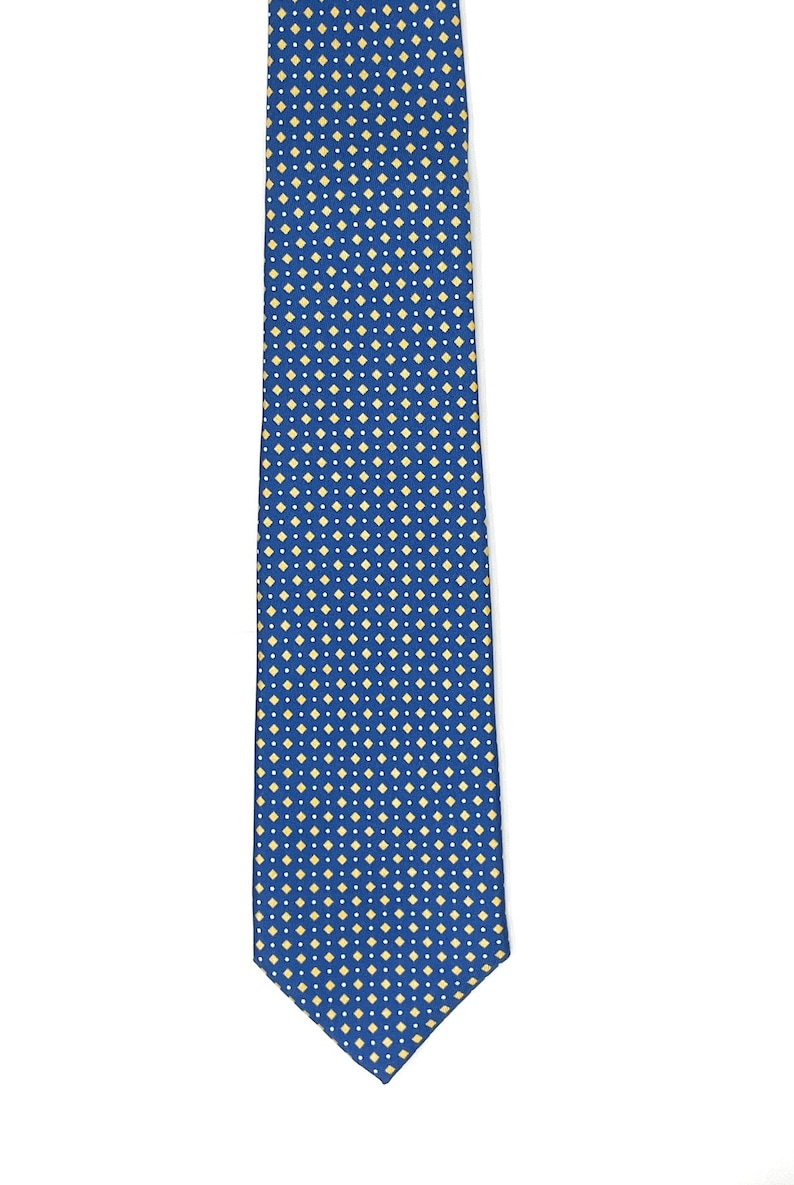 May include: A blue silk tie with a small, white and yellow diamond pattern.