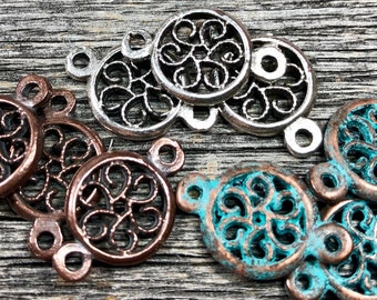 May include: An assortment of decorative metal filigree connectors in various colors. The connectors are round with an openwork design and small loops for attaching to other components. Colors include silver, copper, and turquoise with a rustic finish.