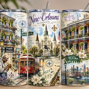 May include: A cylindrical metal tumbler with a straw featuring a colorful collage of New Orleans landmarks, including the French Quarter, a red streetcar, a jazz musician, a steamboat, and text reading New Orleans, French Quarter, and Jazz.