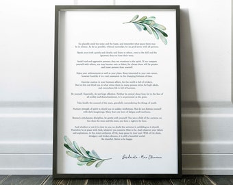 May include: Framed print with the text of the poem "Desiderata" by Max Ehrmann. The print has a black frame and features green and blue watercolor leaf accents. The poem is printed in a classic serif font.