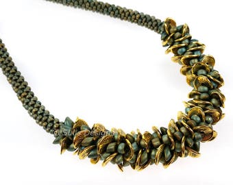 May include: A green and gold beaded necklace with a unique design. The beads are arranged in a spiral pattern, creating a textured and eye-catching look.