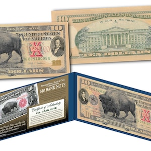 May include: A replica £10 bank note featuring a buffalo on the front and the White House on the back. The note is printed on a textured paper and has a gold foil seal. The note is folded in half and has a certificate of authenticity on the inside.