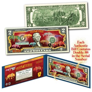 May include: A two dollar bill with a gold overlay featuring a tiger design and the text "Year of the Tiger" and "2022". The bill is folded in half and has a certificate of authenticity.
