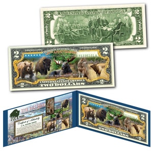 May include: A two dollar bill with a gold border and a picture of the five animals of Yellowstone National Park: a grizzly bear, bison, moose, wolf, and elk. The bill is part of a set celebrating the 150th anniversary of Yellowstone National Park.