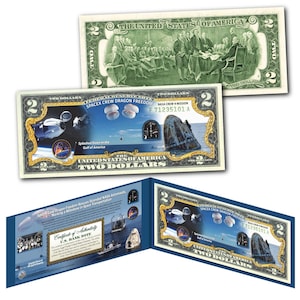 May include: A two dollar bill replica featuring a SpaceX Crew Dragon Freedom spacecraft splashing down in the Gulf of America. The bill has a certificate of authenticity and the text "SpaceX Crew Dragon Freedom Rescue Sounded NASA Astronauts Marking a Milestone in Space Transportation".