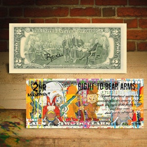 May include: A two dollar bill with a colourful paint splatter design. The bill features a cartoon image of Bugs Bunny holding a rifle and the text "Right to Bear Arms". The text of the Second Amendment is also visible on the bill.