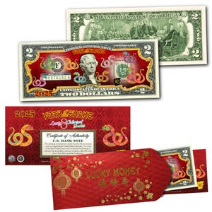 May include: A red and gold $2 bill featuring a snake design, celebrating the Year of the Snake. The bill is part of a set that includes a red envelope with the words "Lucky Money" and Chinese characters.