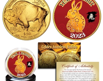 May include: A gold-plated replica of the American Buffalo coin with a red and gold design featuring a rabbit and the Chinese characters for "rabbit" and "2023". The coin is displayed on a black stand with a clear plastic case. The certificate of authenticity states that the coin is a 34 mm clad 24KT Gold Plated replica of the American Buffalo Gold Bullion Coin.