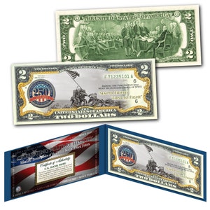 May include: A commemorative two-dollar bill with a black and white image of the flag raising on Iwo Jima. The bill features a gold seal with the text "250th Anniversary 1775-2025". The bill also includes the text "F 71235101 A" and "Raising the Flag on Iwo Jima, Most Recognizable Image of WWII" and "Semper Fidelis, First to Fight".