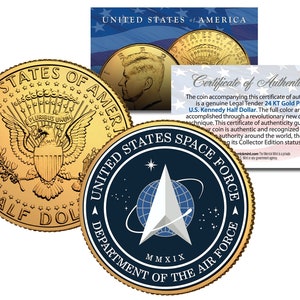 May include: A gold-plated half dollar coin featuring the United States seal and the words "United States of America" and "Half Dollar". The coin is accompanied by a certificate of authenticity and a second coin featuring the United States Space Force logo and the text "United States Space Force Department of the Air Force MMXIX".