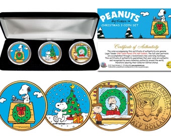 May include: A set of three gold-plated half-dollar coins featuring Peanuts characters celebrating Christmas. The coins are in a black velvet box with a certificate of authenticity. The coins feature Snoopy typing on a typewriter, Snoopy and Woodstock decorating a Christmas tree, and Charlie Brown and Snoopy looking out a window.