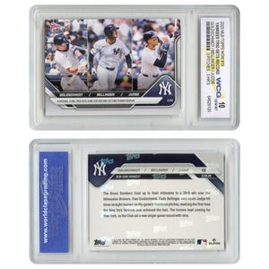 May include: A baseball card featuring three baseball players, Paul Goldschmidt, Cody Bellinger, and Aaron Judge, in their New York Yankees uniforms. The card is from the 2025 Topps Now series and features the text "Yankees Trio Sets Record" and "3 Pitches, 3 HR's".