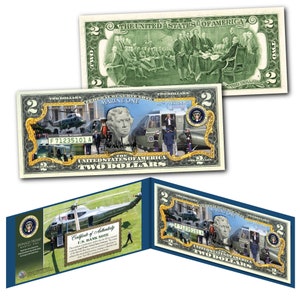 May include: A two dollar bill replica featuring a green and gold design with a helicopter and the words "Marine One" and "Donald Trump 45th President".