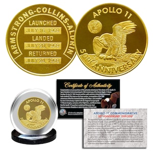 May include: Gold Apollo 11 50th Anniversary commemorative medallions. One shows an eagle and "50th Anniversary". Another displays launch, landing, and return dates. Includes a certificate of authenticity.