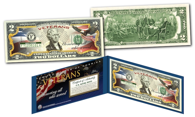 May include: A two-dollar bill replica with a gold border and a portrait of George Washington. The bill features the text "Veterans Honoring all who served" and a certificate of authenticity.