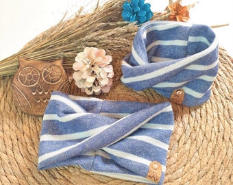 May include: Two blue and white striped fabric headbands with brown leather labels. The labels have the word "Ika" printed on them.