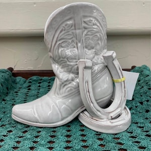 May include: A set of three ceramic vases in varying heights. The vases are white with a textured, ribbed design. The tallest vase is approximately 10 inches tall, the medium vase is 8 inches, and the smallest is 6 inches.