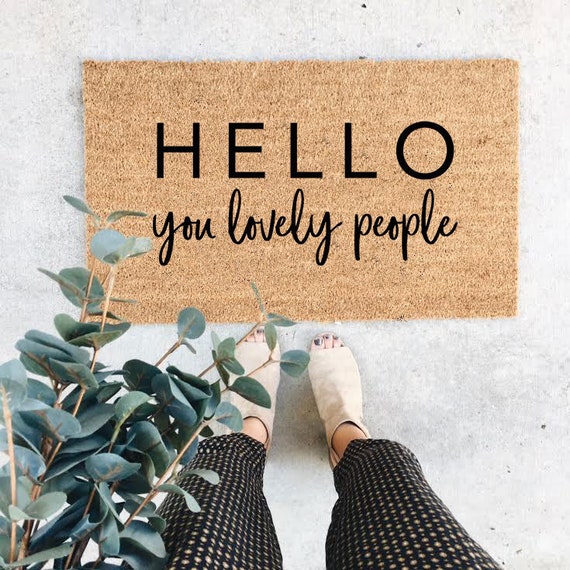 Whimsical doormat HELLO YOU LOVELY PEOPLE by SkytoSeaCreativeCo on Etsy.