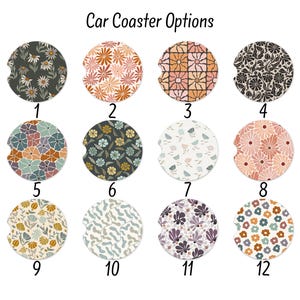 May include: Twelve car coasters with various floral and abstract patterns are displayed. The coasters feature designs with daisies, geometric shapes, and other botanical elements in colors like orange, green, and purple. The text "Car Coaster Options" is at the top.