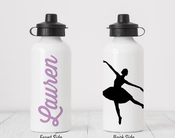 May include: White water bottle with a purple cursive name "Lauren" on the front and a black silhouette of a ballerina on the back.