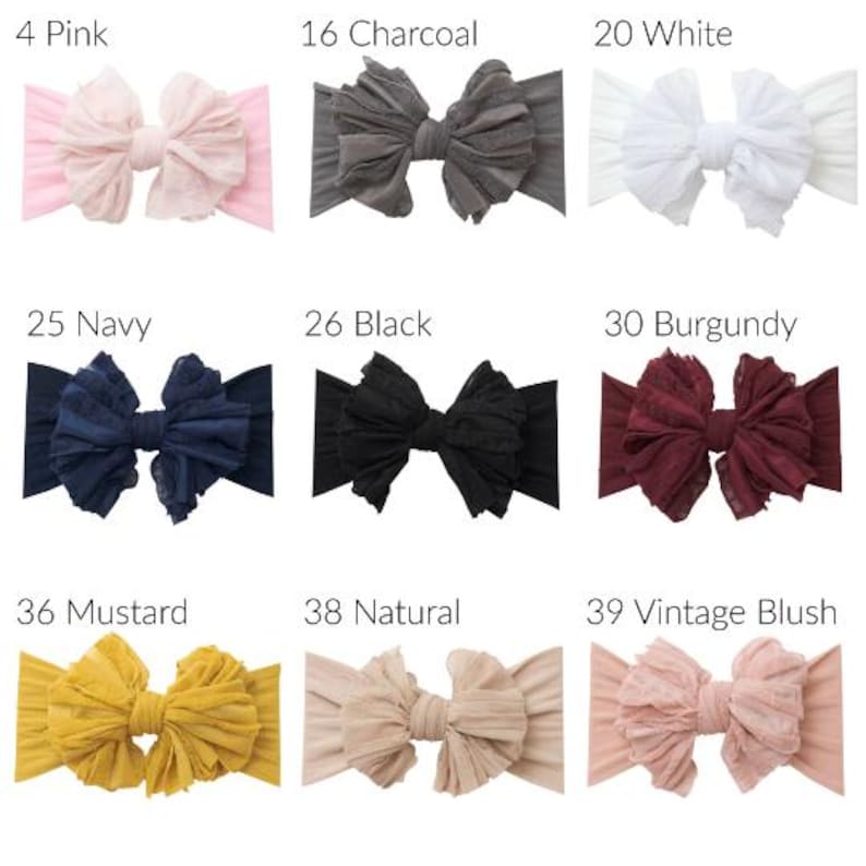 May include: A collection of nine fabric headbands with large, ruffled bows in various colors labeled 4 Pink, 16 Charcoal, 20 White, 25 Navy, 26 Black, 30 Burgundy, 36 Mustard, 38 Natural, and 39 Vintage Blush, each featuring a textured, layered design.