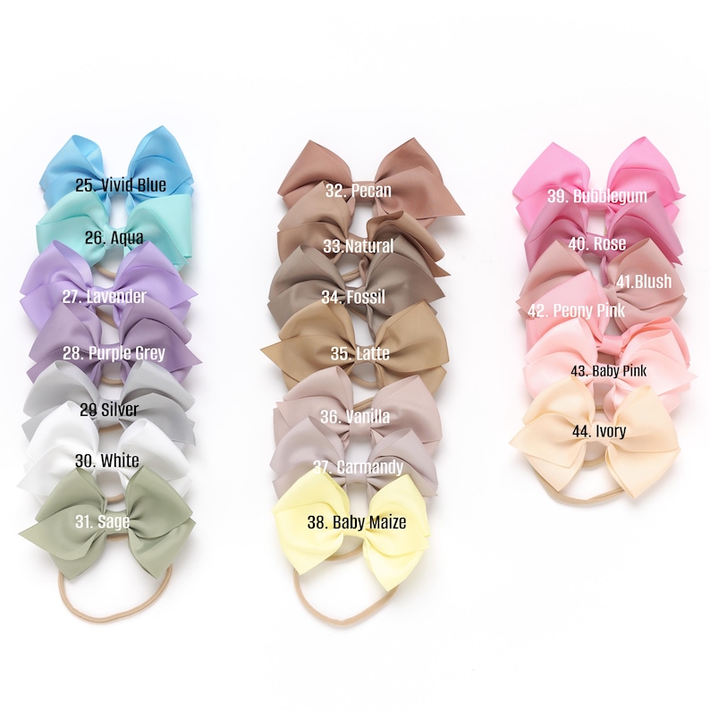 May include: A set of 20 hair bows in various colors, including vivid blue, aqua, lavender, purple grey, silver, white, sage, pecan, natural, fossil, latte, vanilla, carmandy, baby maize, bubblegum, rose, blush, peony pink, baby pink, and ivory. Each bow is tied with a matching elastic headband.
