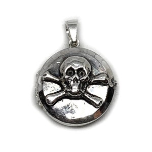 May include: Silver locket pendant with a skull and crossbones design.