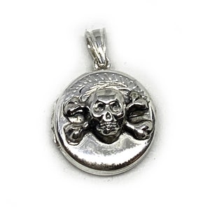 May include: Silver locket pendant with a skull and crossbones design.